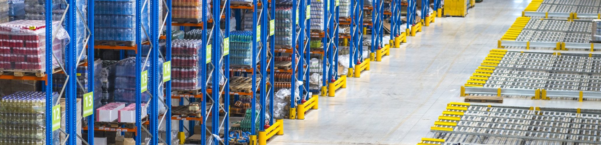 Distribution warehouse building interior and large storage area with goods on the shelf.